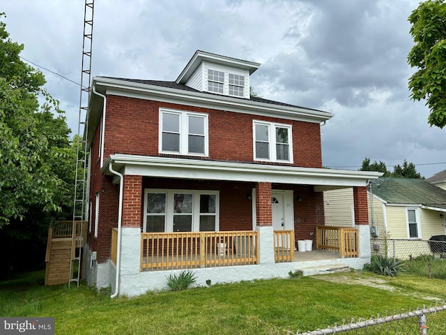 view of front of house with covered porch and a front lawn