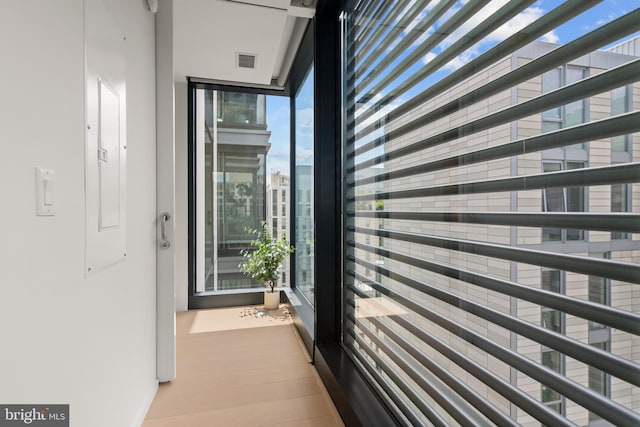 corridor with light hardwood / wood-style floors