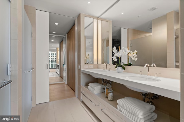 bathroom with tile patterned flooring and vanity