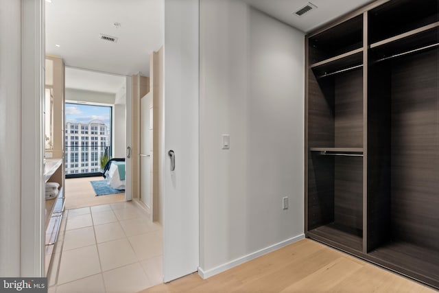 walk in closet featuring light tile patterned flooring