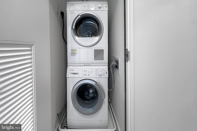 laundry room featuring stacked washer and dryer