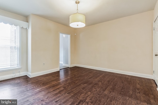 empty room featuring dark wood-type flooring