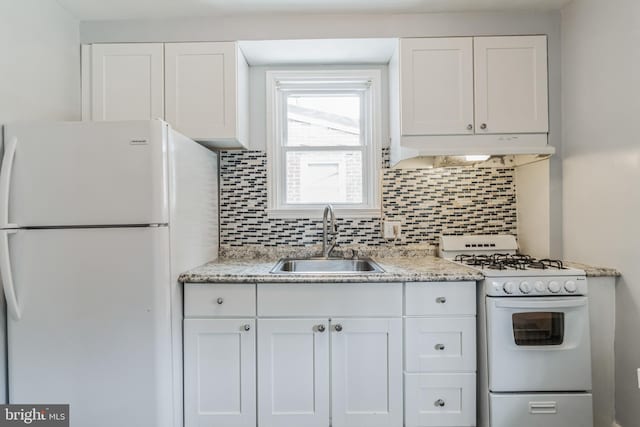 kitchen with white cabinetry, custom range hood, white appliances, and sink