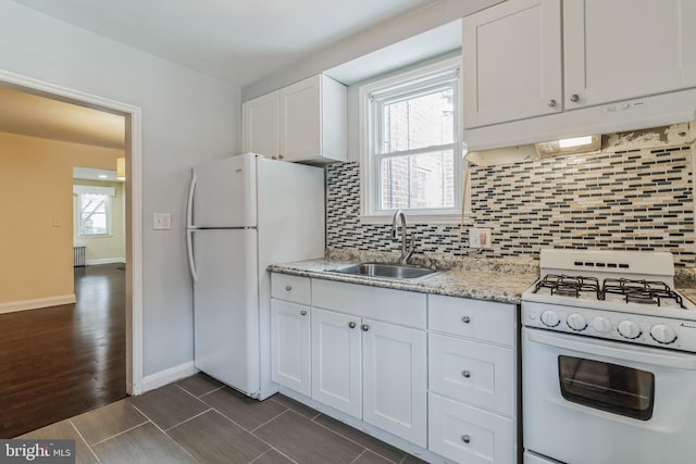 kitchen featuring a healthy amount of sunlight, white appliances, sink, and white cabinets