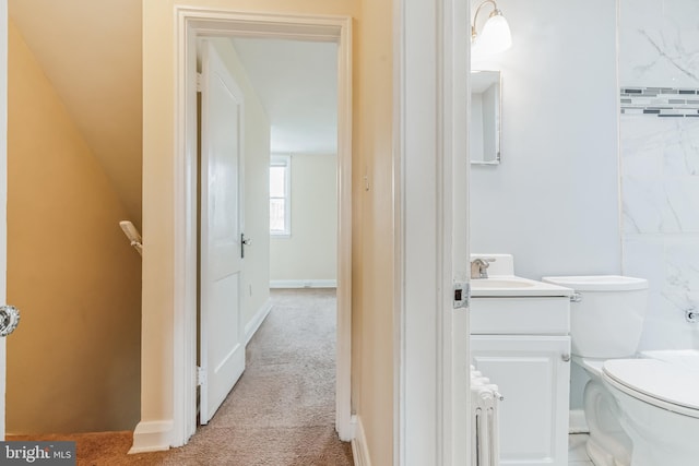 bathroom with toilet and large vanity