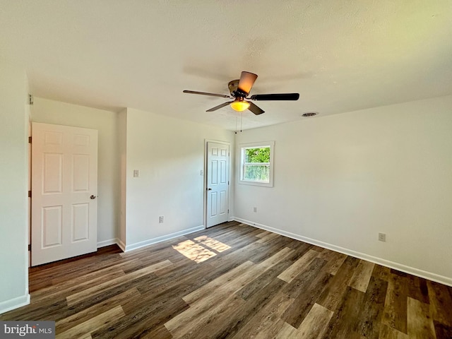 unfurnished room with ceiling fan and dark hardwood / wood-style floors