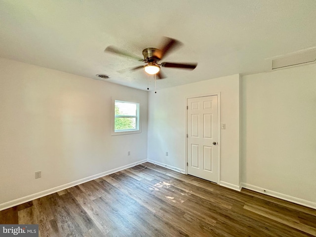 empty room with dark hardwood / wood-style flooring and ceiling fan