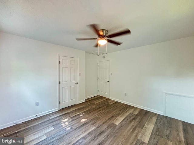 unfurnished room featuring dark hardwood / wood-style floors and ceiling fan