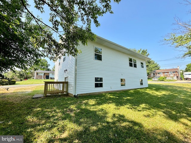 view of side of home with a lawn