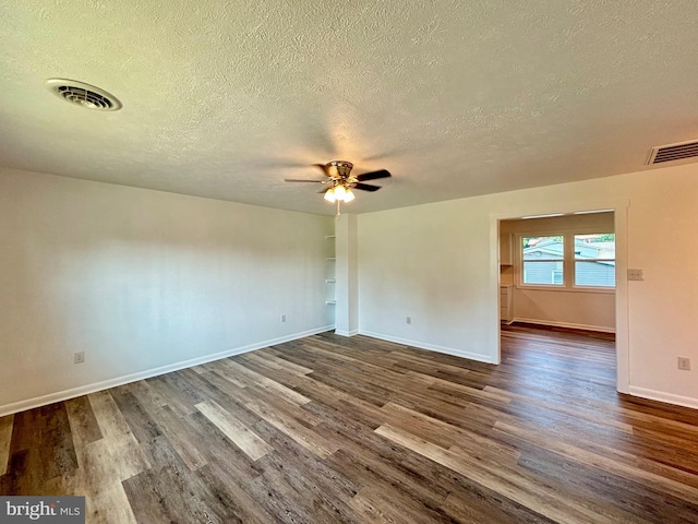 empty room featuring ceiling fan, dark hardwood / wood-style flooring, and a textured ceiling