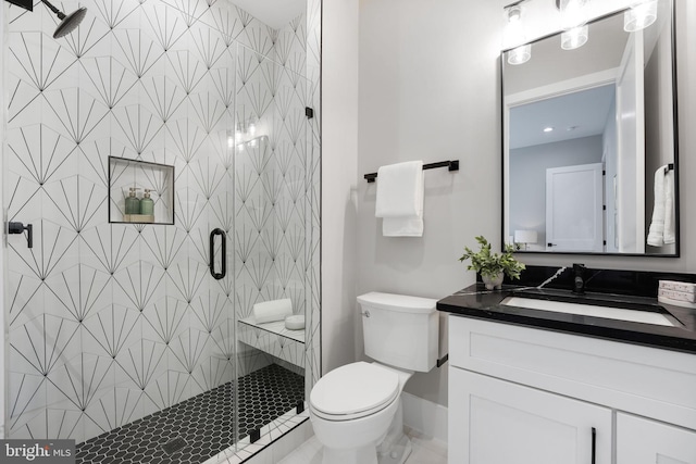 bathroom with vanity, an enclosed shower, and toilet