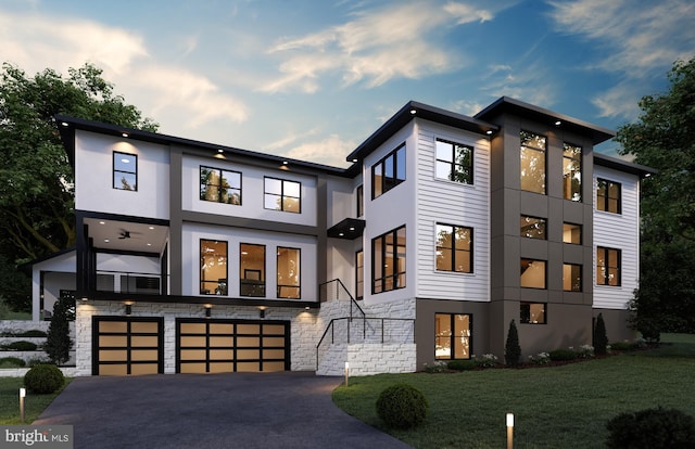 modern home featuring a front yard and a garage