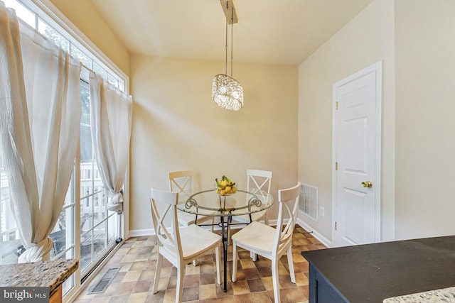 dining space with a chandelier