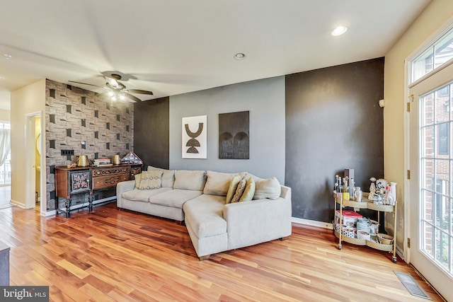 living room with ceiling fan and light hardwood / wood-style floors