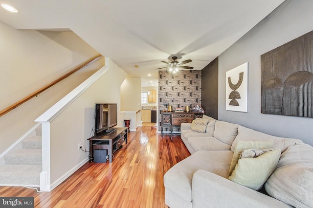 living room with ceiling fan and hardwood / wood-style flooring