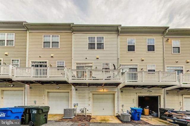 rear view of property with central AC