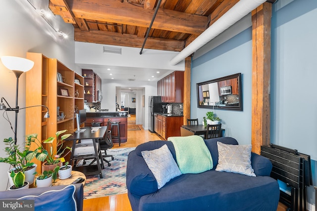 living room with beamed ceiling, wooden ceiling, and light hardwood / wood-style floors