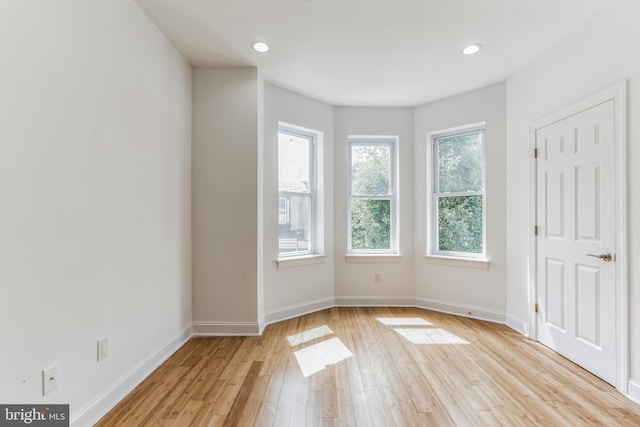 spare room with light hardwood / wood-style flooring