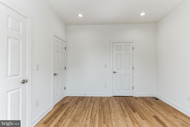 spare room featuring light hardwood / wood-style flooring