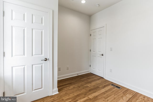 unfurnished room with hardwood / wood-style floors