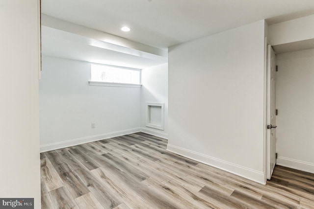 basement with light hardwood / wood-style flooring