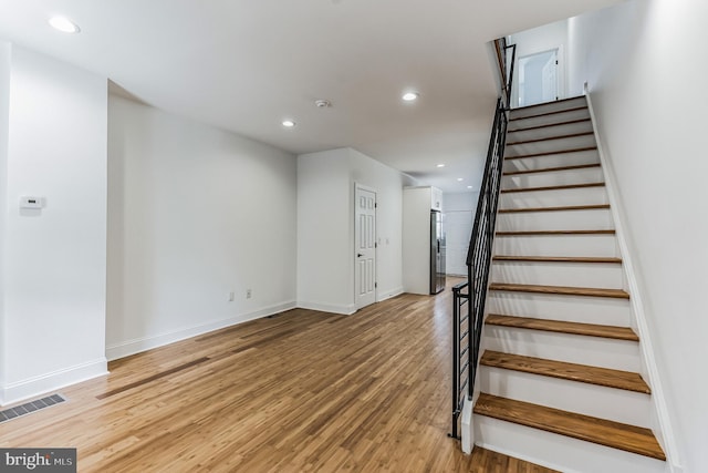 staircase featuring light hardwood / wood-style floors