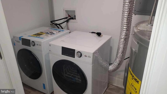 washroom with hookup for a washing machine, washer and clothes dryer, and electric water heater