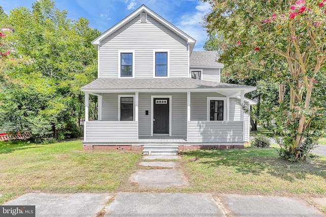 view of front of property featuring covered porch and a front lawn