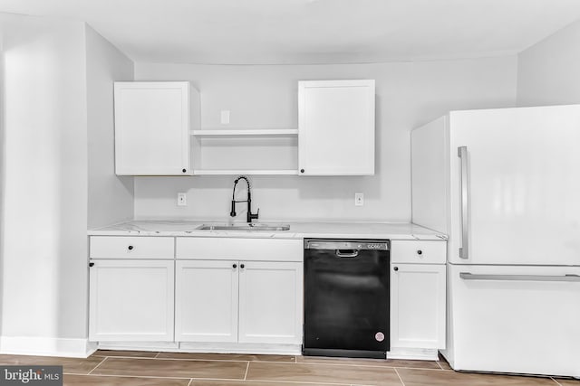 kitchen with dishwasher, open shelves, freestanding refrigerator, and white cabinets