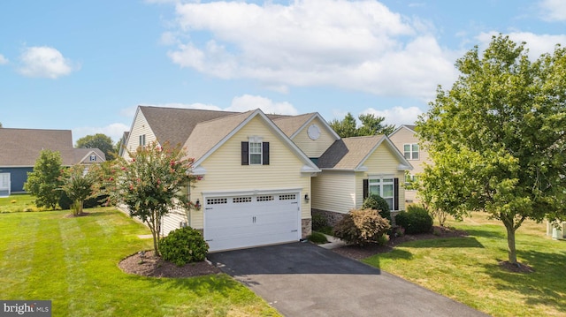 view of front of property with a garage and a front yard