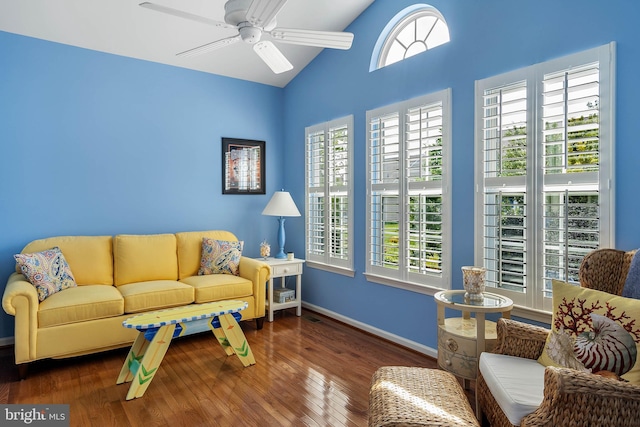 living room with ceiling fan, dark hardwood / wood-style floors, and lofted ceiling