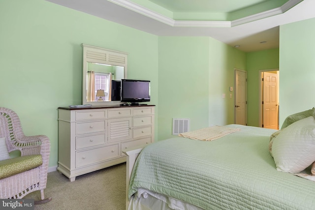 carpeted bedroom featuring ornamental molding and a raised ceiling