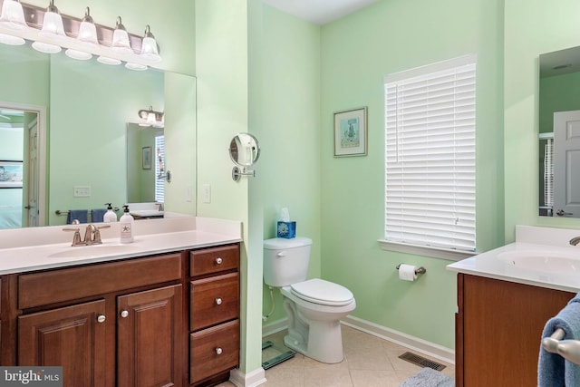 bathroom with toilet, tile floors, and large vanity