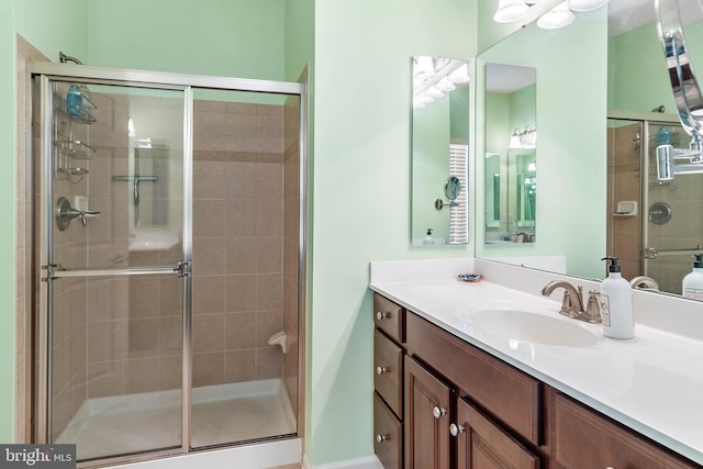 bathroom featuring walk in shower and large vanity