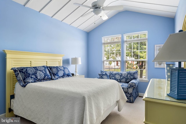 bedroom featuring ceiling fan, vaulted ceiling, carpet, and multiple windows