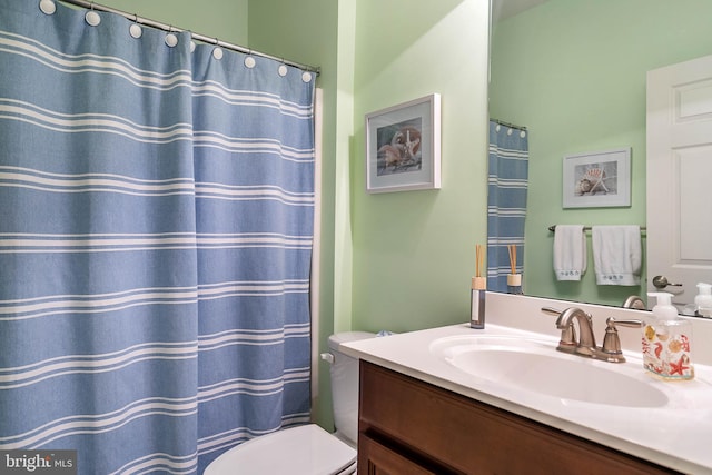 bathroom featuring oversized vanity and toilet