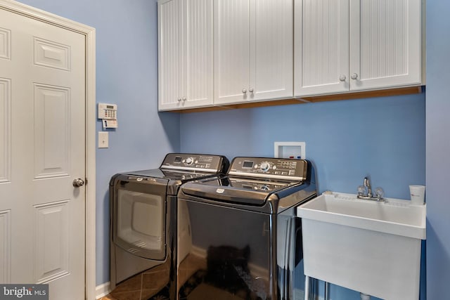 laundry area featuring washer hookup, washing machine and dryer, cabinets, and sink