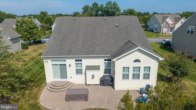 back of property with a patio