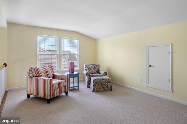 sitting room featuring vaulted ceiling and carpet floors