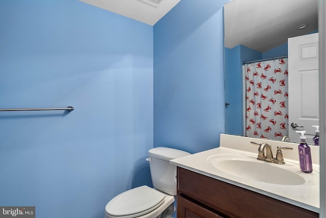 bathroom featuring toilet and large vanity