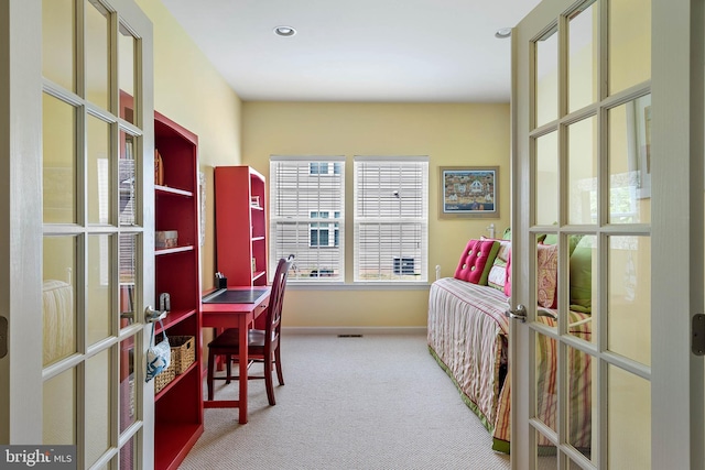 carpeted office space featuring french doors