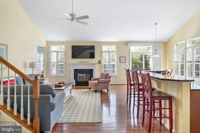 living room featuring high vaulted ceiling, hardwood / wood-style floors, and ceiling fan