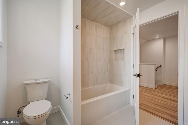 bathroom with toilet, shower / bathing tub combination, and hardwood / wood-style floors