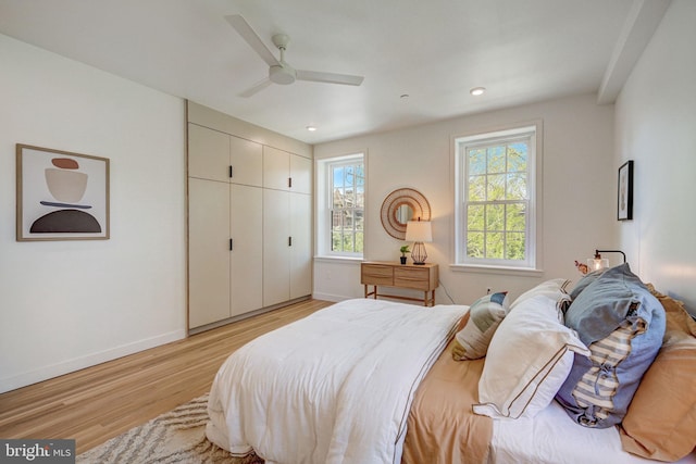 bedroom featuring a closet, ceiling fan, and light hardwood / wood-style floors