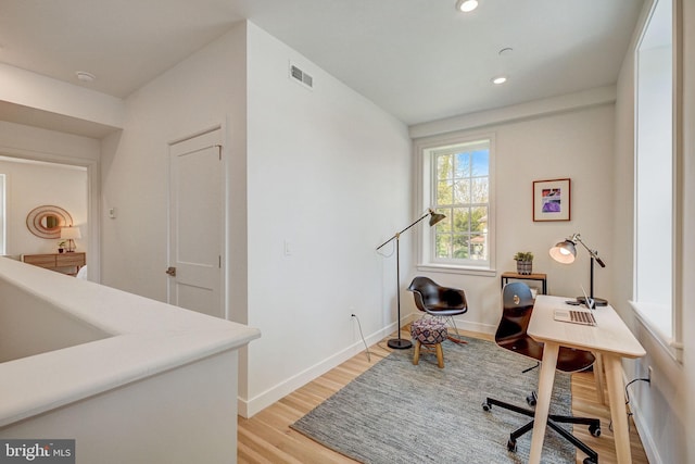 office space with light wood-type flooring