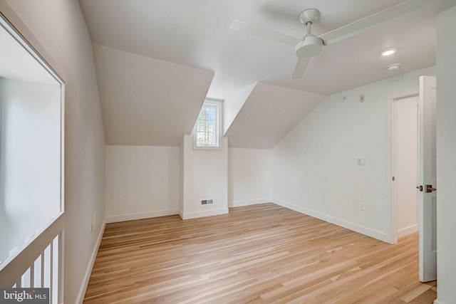 additional living space featuring vaulted ceiling, ceiling fan, and light wood-type flooring