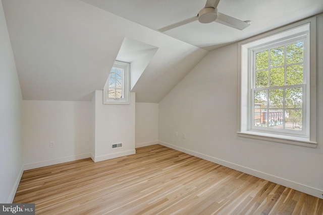 bonus room with vaulted ceiling, light hardwood / wood-style flooring, ceiling fan, and a wealth of natural light