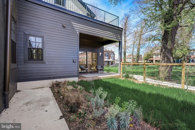 view of yard with a patio and a balcony