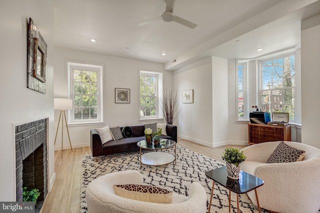 living room with ceiling fan and light wood-type flooring