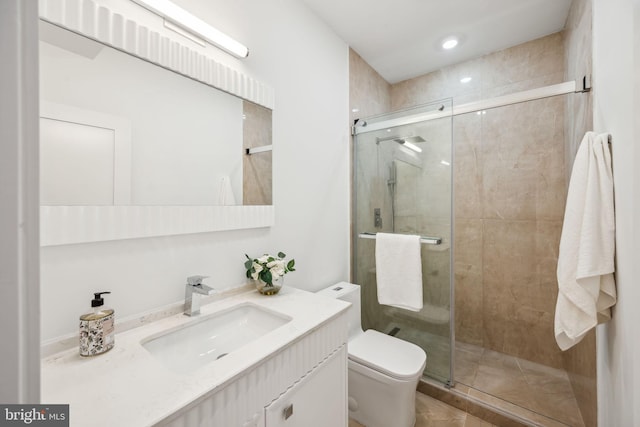 bathroom with vanity, a shower with shower door, and toilet